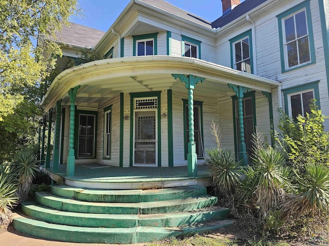 view of exterior entry featuring a porch