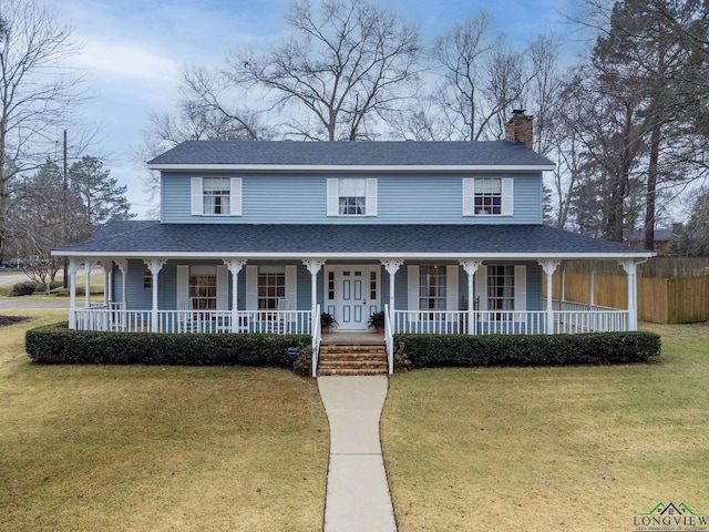 farmhouse with a front yard and covered porch