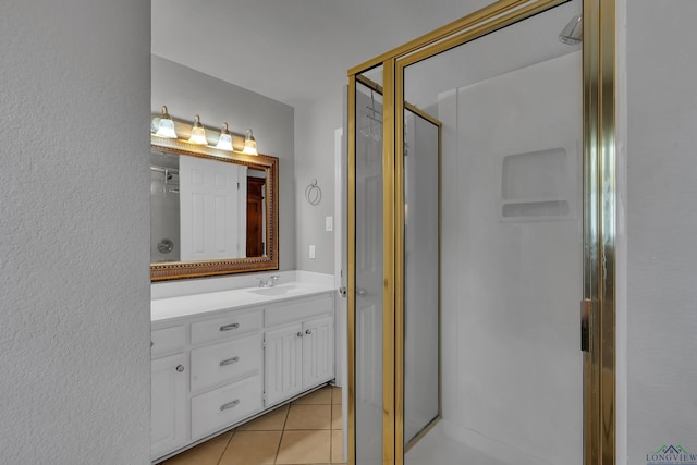 bathroom with vanity, tile patterned floors, and a shower with shower door