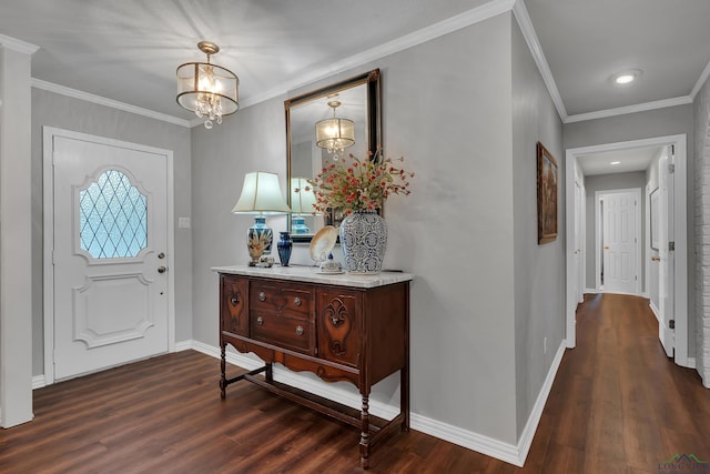 foyer with an inviting chandelier, crown molding, and dark wood-type flooring