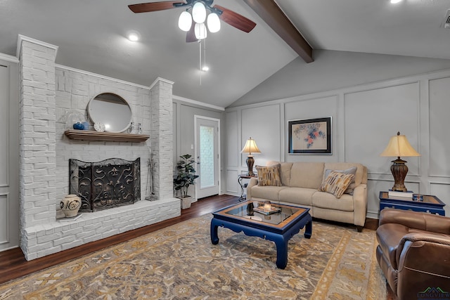 living room with ceiling fan, a fireplace, dark hardwood / wood-style flooring, and lofted ceiling with beams