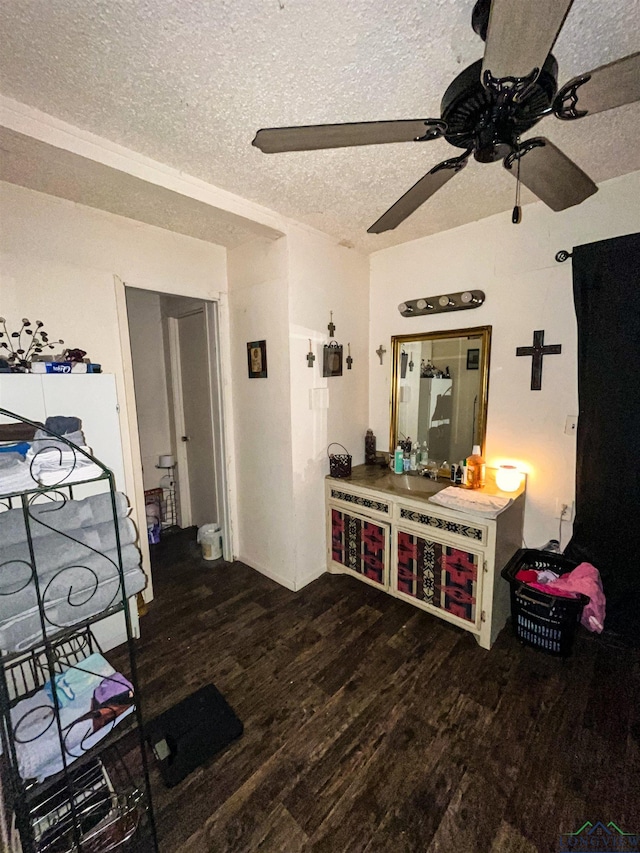 interior space with dark wood-type flooring, a textured ceiling, and ceiling fan