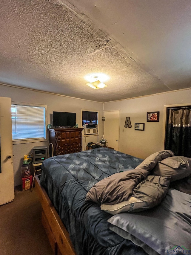 carpeted bedroom with a textured ceiling