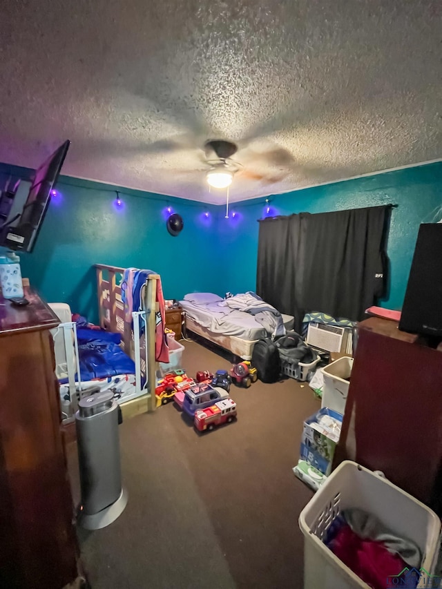 bedroom with ceiling fan and a textured ceiling