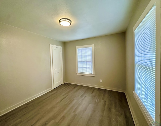1407 E US-80, White Oak, TX 75693 - empty room featuring dark wood-type flooring and baseboards