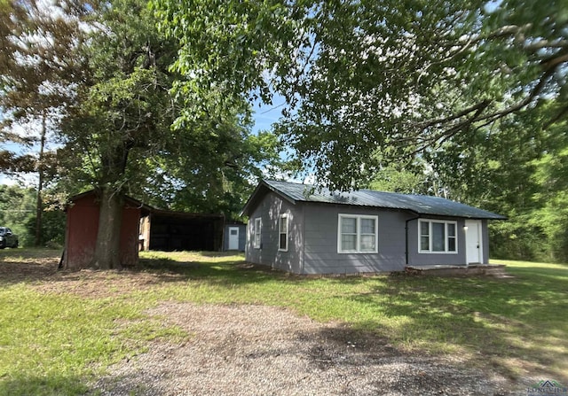 1407 E US-80, White Oak, TX 75693 - view of side of home with a yard and an outdoor structure