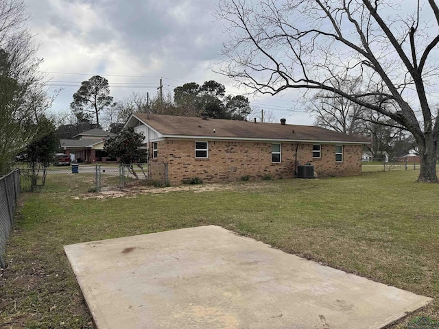 back of house with a patio, brick siding, central AC, and fence