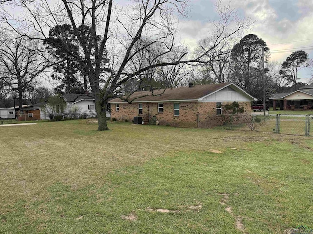 view of yard with fence and central AC