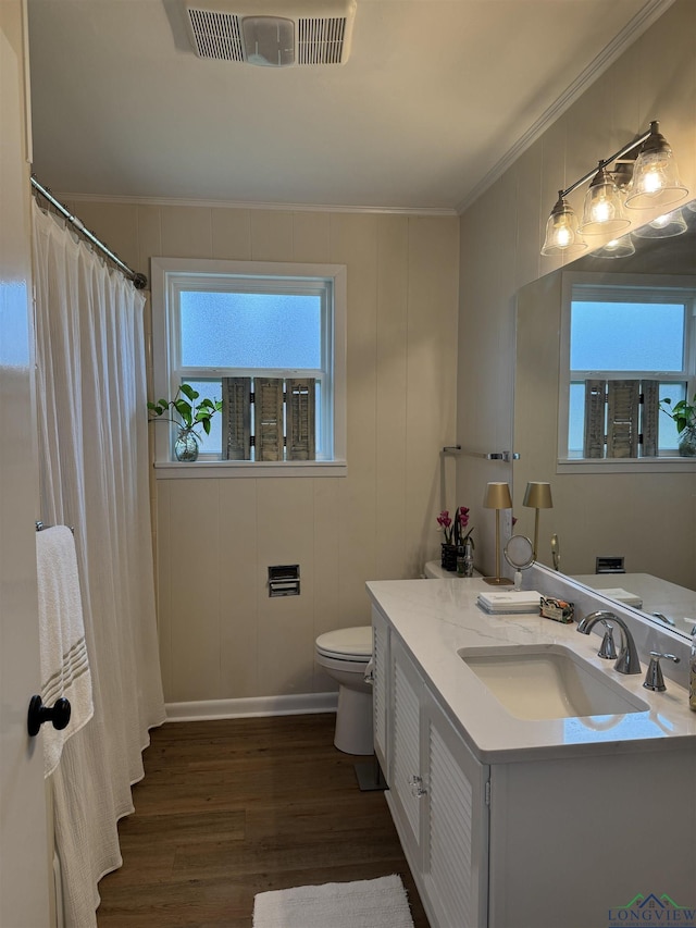 full bath featuring visible vents, toilet, wood finished floors, crown molding, and vanity