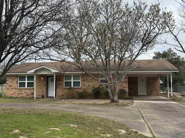 single story home featuring concrete driveway, fence, and brick siding