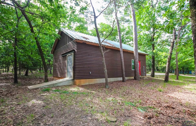 325 Laurel Ln, Holly Lake Ranch, TX 75765 - view of property exterior with log veneer siding and metal roof