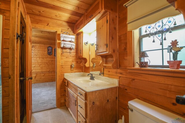 325 Laurel Ln, Holly Lake Ranch, TX 75765 - bathroom featuring wood walls, toilet, wooden ceiling, vanity, and tile patterned floors