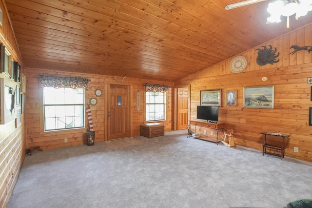325 Laurel Ln, Holly Lake Ranch, TX 75765 - unfurnished living room with wood walls, vaulted ceiling, ceiling fan, carpet flooring, and wooden ceiling