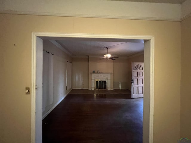 corridor with ornamental molding and dark wood-type flooring