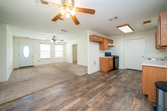 620 County Road 3332, Omaha, TX 75571 - kitchen with brown cabinetry, visible vents, a sink, and black gas range