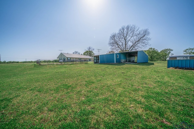 620 County Road 3332, Omaha, TX 75571 - view of yard featuring a carport, an outbuilding, fence, and an outdoor structure