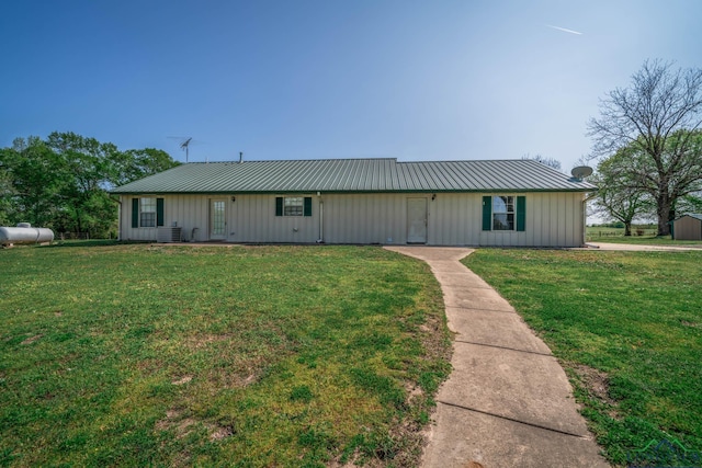 620 County Road 3332, Omaha, TX 75571 - view of front facade with board and batten siding, metal roof, and a front yard