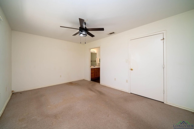 620 County Road 3332, Omaha, TX 75571 - unfurnished bedroom featuring baseboards, connected bathroom, visible vents, ceiling fan, and carpet