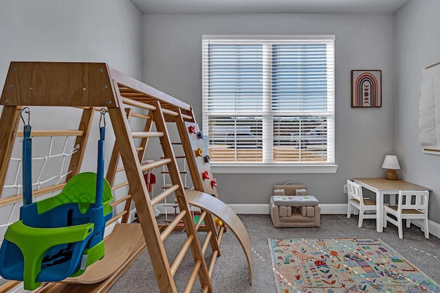 bedroom featuring carpet, multiple windows, and baseboards