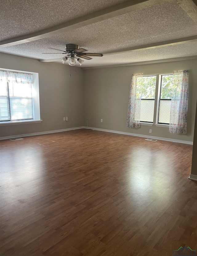 spare room with ceiling fan, dark hardwood / wood-style floors, and a textured ceiling