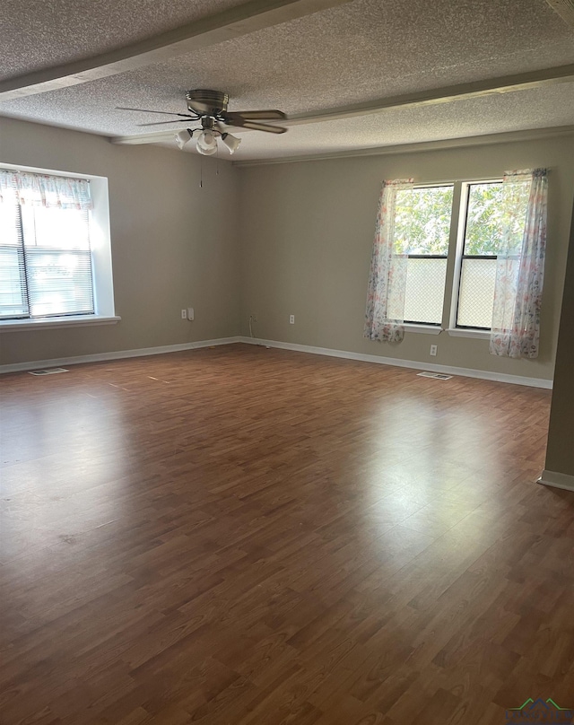 unfurnished room featuring a textured ceiling, ceiling fan, and dark wood-type flooring