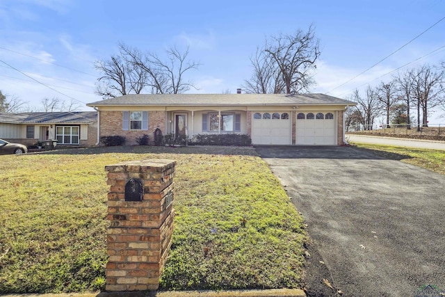 view of front of house featuring a garage and a front lawn