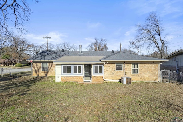 back of property featuring cooling unit and a yard