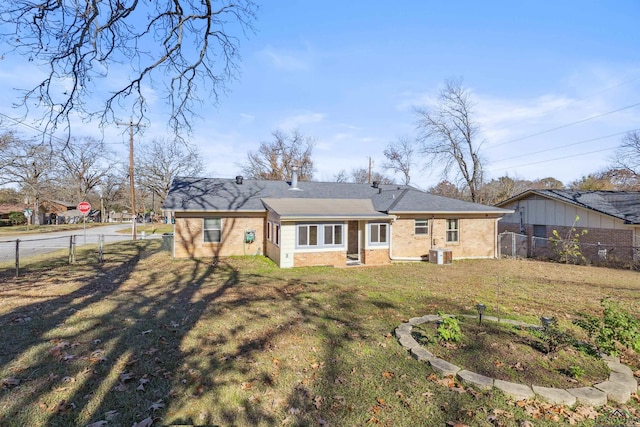 back of house featuring a yard and central AC unit