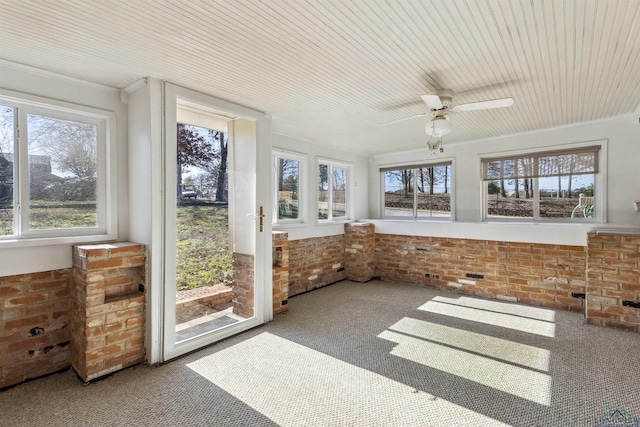 unfurnished sunroom with ceiling fan and a healthy amount of sunlight