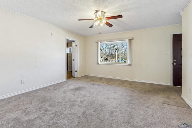 carpeted spare room with a textured ceiling and ceiling fan