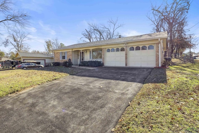 single story home with a front yard and a garage