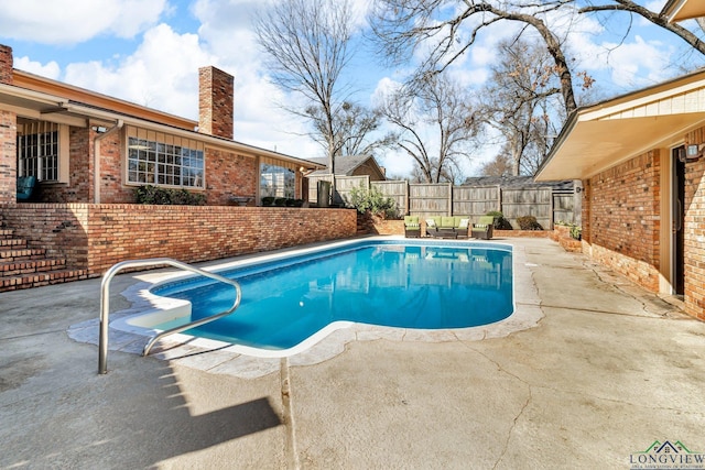 view of pool featuring a patio area, a fenced backyard, and a fenced in pool