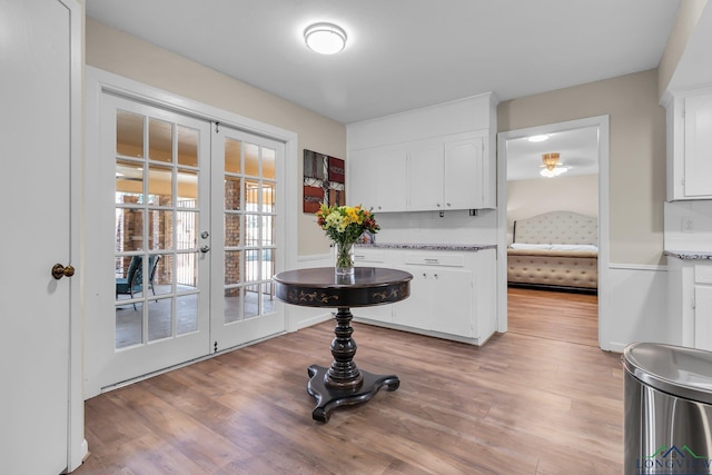 interior space with french doors and light wood-style floors