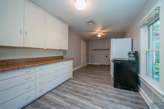 kitchen featuring white cabinetry, light hardwood / wood-style flooring, ceiling fan, and range with electric cooktop