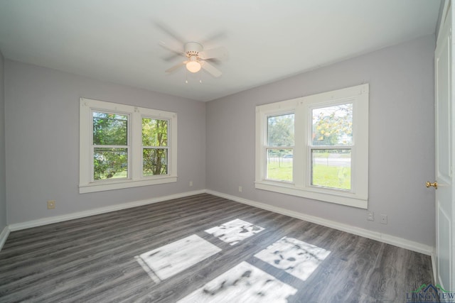 unfurnished room with ceiling fan and dark wood-type flooring