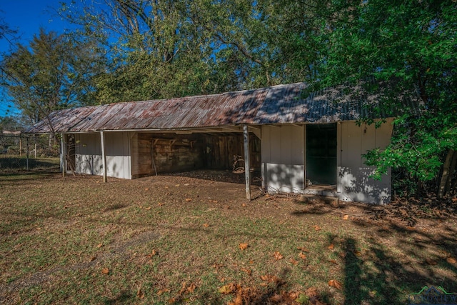 view of outbuilding featuring a lawn