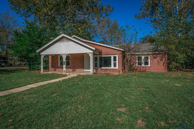 ranch-style home with a porch and a front yard