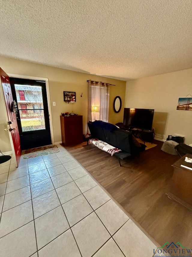 living room featuring tile patterned flooring and a textured ceiling