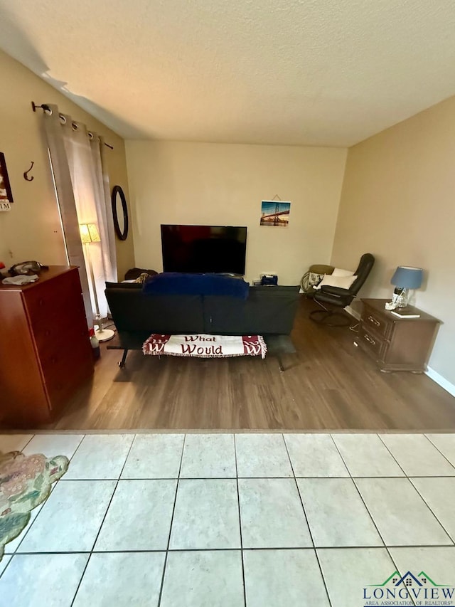 bedroom with tile patterned floors and a textured ceiling