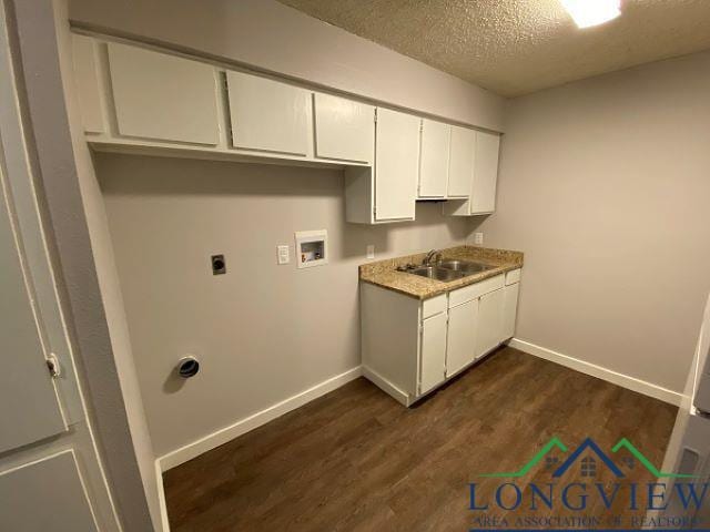 washroom featuring sink, hookup for a washing machine, dark hardwood / wood-style floors, a textured ceiling, and hookup for an electric dryer