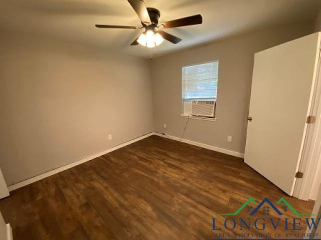 spare room featuring ceiling fan, cooling unit, and dark wood-type flooring