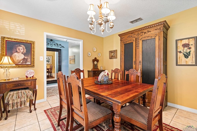 dining area with a chandelier, baseboards, light tile patterned floors, and visible vents