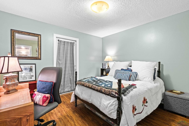 bedroom featuring a textured ceiling and wood finished floors
