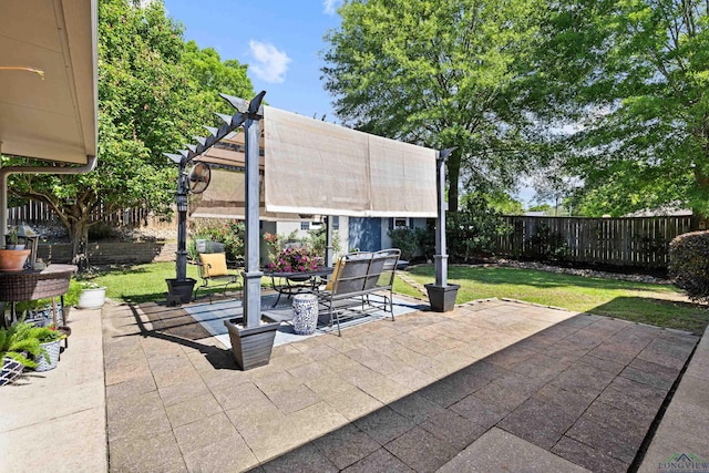view of patio / terrace featuring outdoor dining space, a pergola, and a fenced backyard