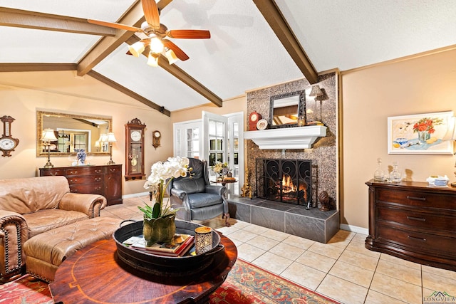 living room with ceiling fan, light tile patterned flooring, vaulted ceiling with beams, and a tile fireplace