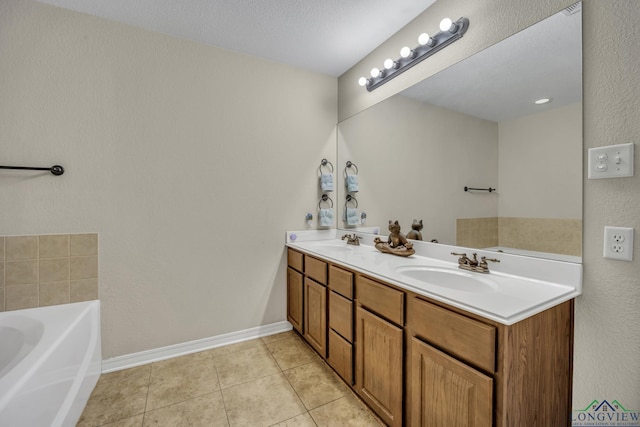 full bathroom with a garden tub, baseboards, a sink, and tile patterned floors