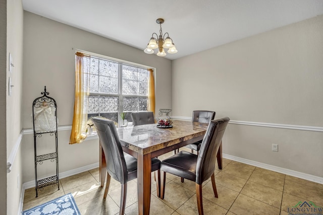 dining room featuring a chandelier, baseboards, and light tile patterned floors