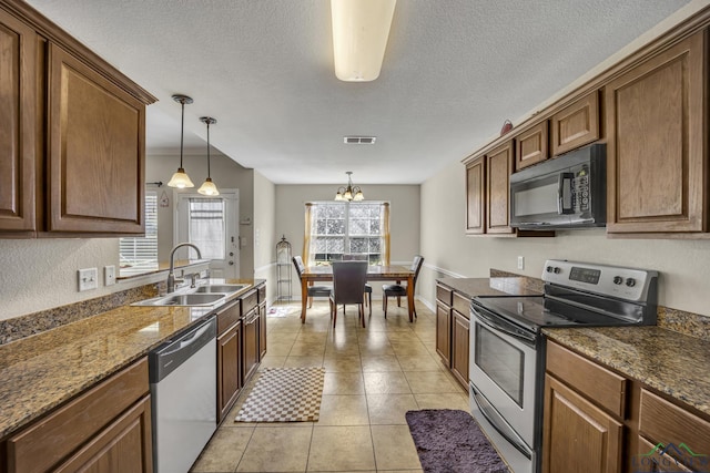 kitchen featuring electric range, visible vents, dishwasher, black microwave, and a sink