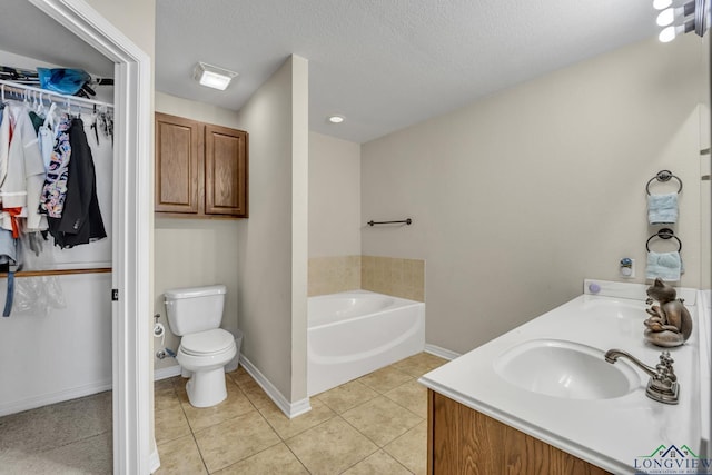 full bath with toilet, a walk in closet, a sink, and tile patterned floors