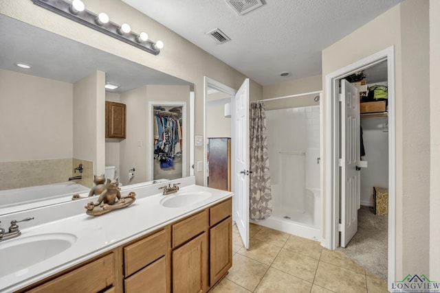 bathroom with tile patterned flooring, visible vents, and a sink